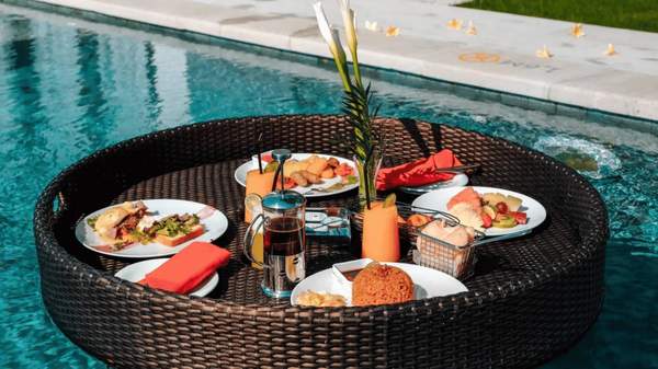 Breakfast dishes floating in the pool.