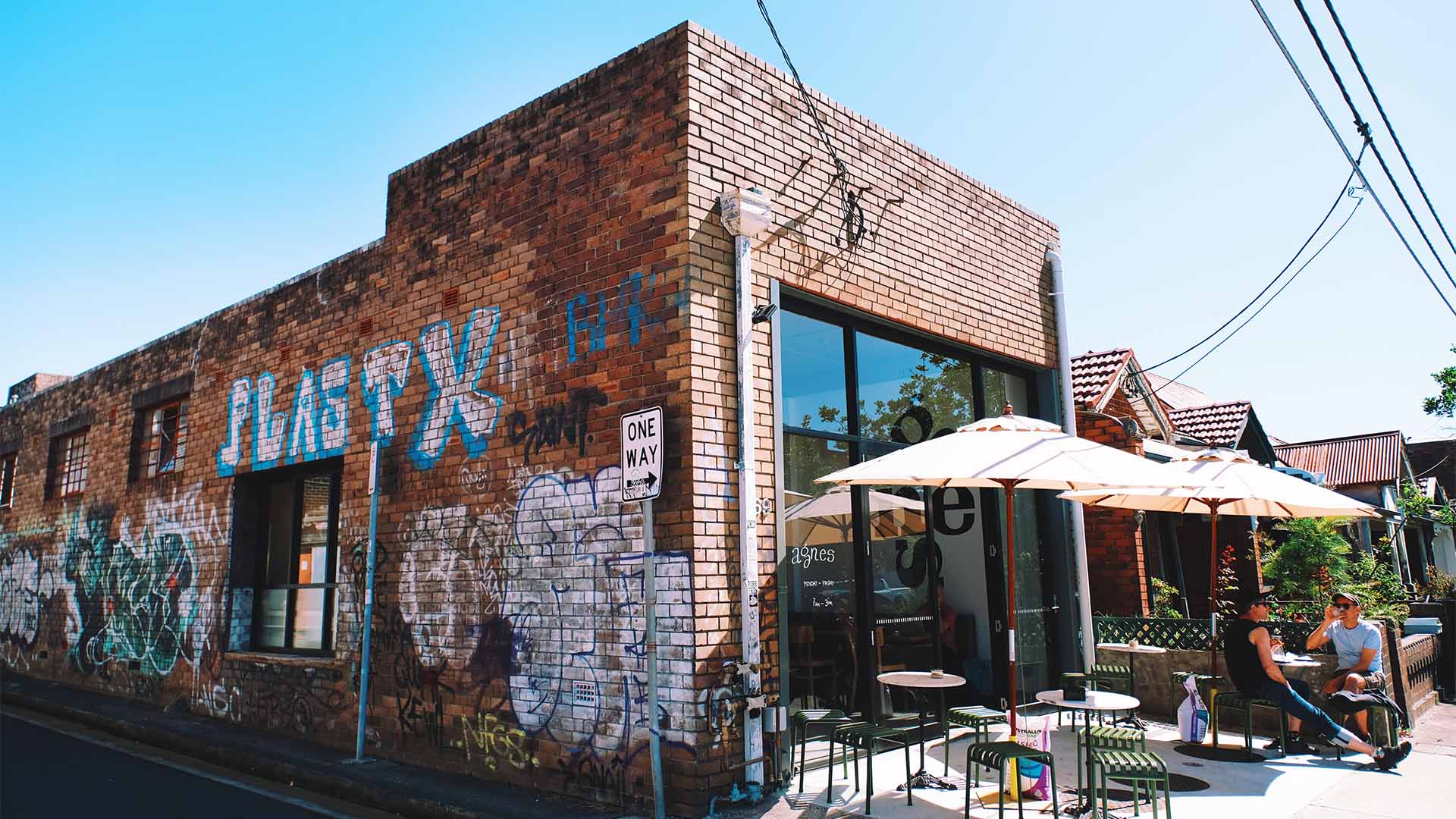 A red brick cafe covered in graffiti in Marrickville