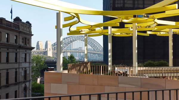A breezy rooftop bar with the Sydney Harbour Bridge in the background