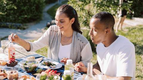 A couple having a picnic outdoors.