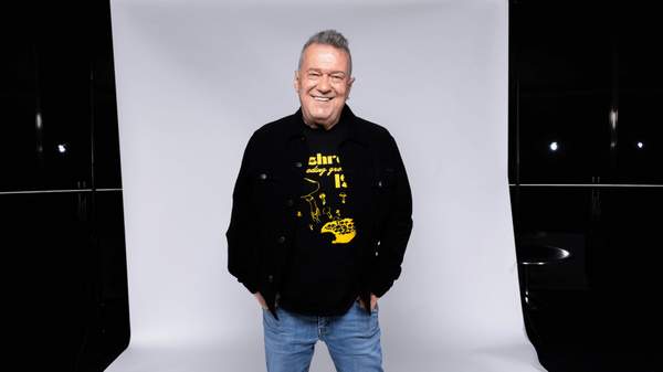 Jimmy Barnes posing in front of a white backdrop.