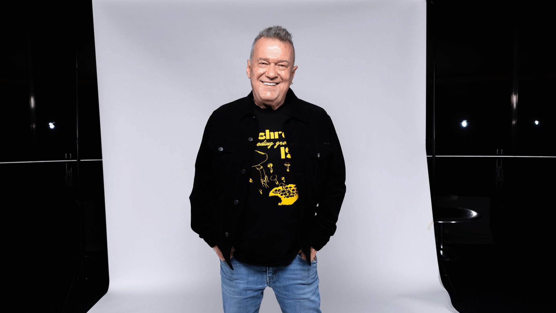 Jimmy Barnes posing in front of a white backdrop.