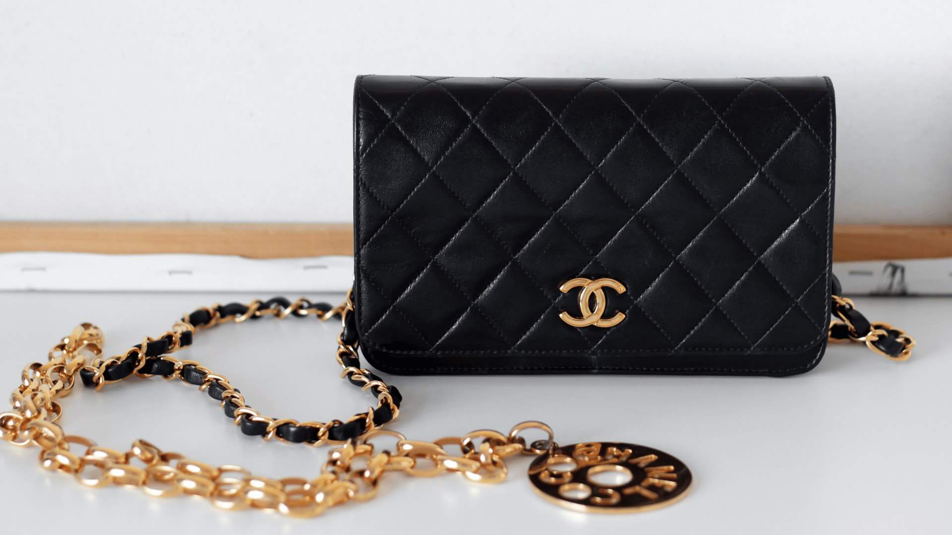 A black Chanel bag and Chanel necklace.