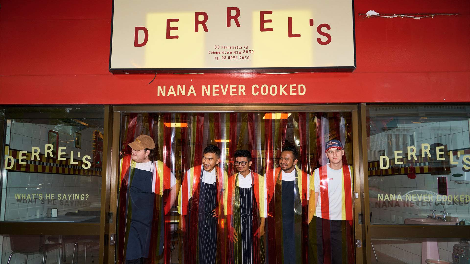 The Derrel's team stands outside of the Camperdown restaurant. There is a cream and red sign sporting the venue's name and red and white plastic streamers synonymous with suburban butcher shops hanging out the front.