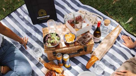 A couple having a picnic outdoors.