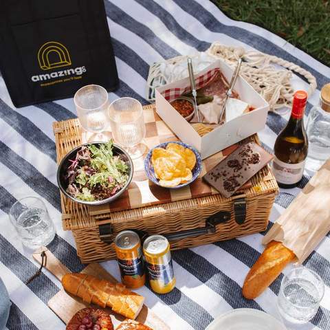 A couple having a picnic outdoors.