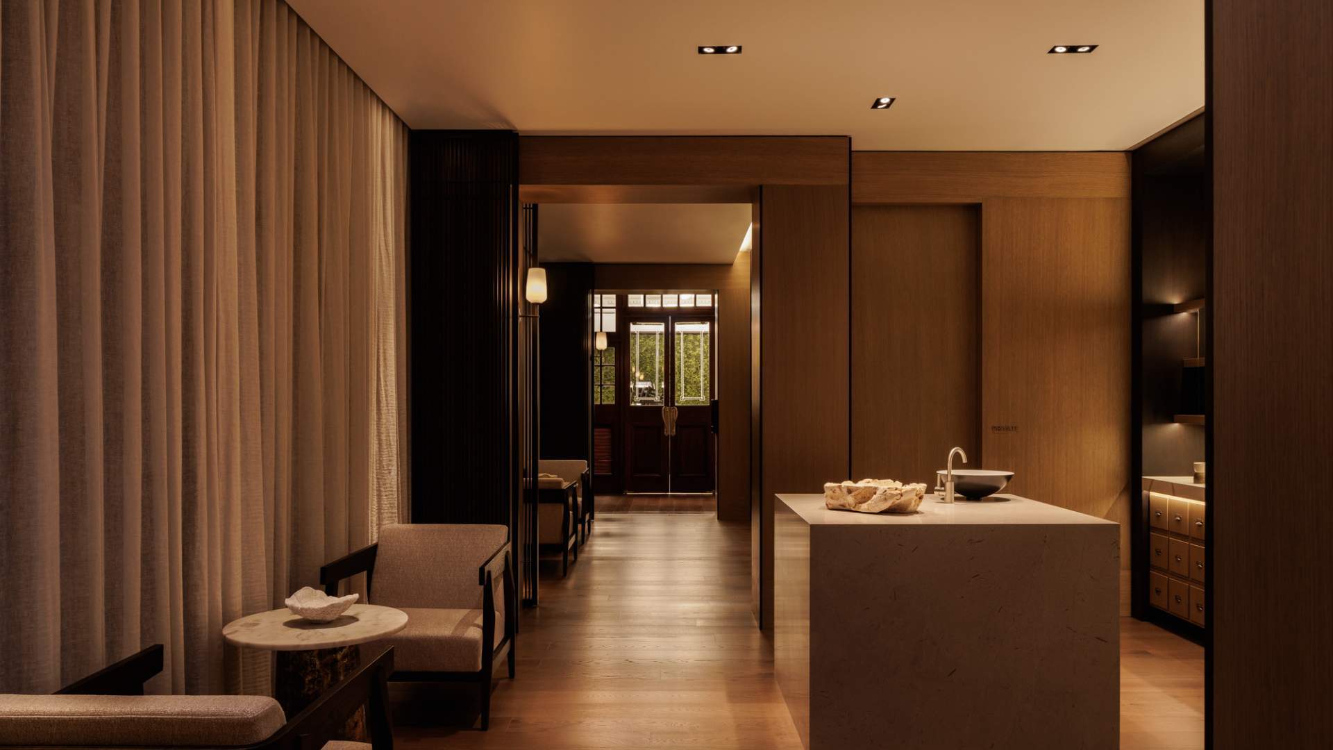 The Capella Hotel Sydney's luxurious Auriga Spa foyer with timber floorboards and warm muted lighting.