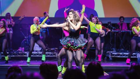 The 80s Ladies performing on stage.