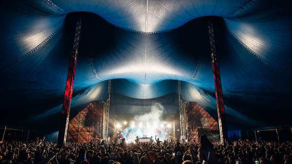 A festival tent packed with people as a DJ performs at Groovin the Moo.