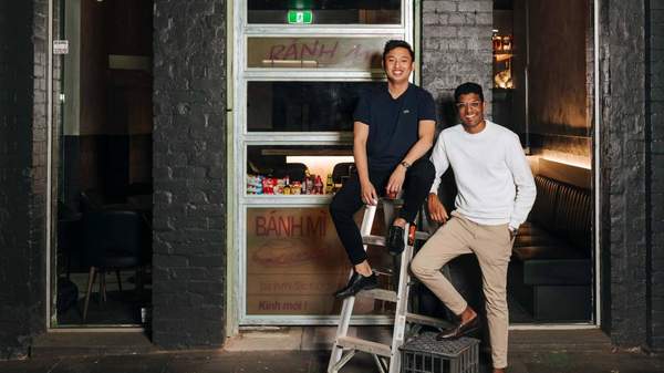 Vinabar owners Reymark Tesalona and Ashwin Arumugam smiling as they perch out the front of their newly-opened bar.