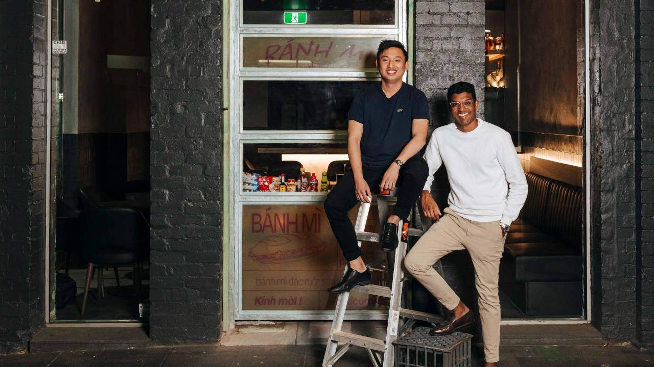 Vinabar owners Reymark Tesalona and Ashwin Arumugam smiling as they perch out the front of their newly-opened bar.