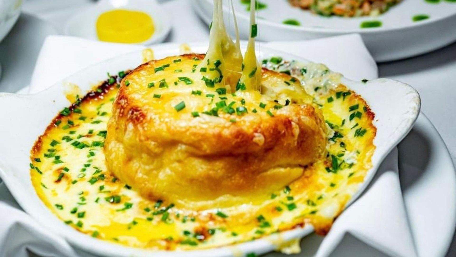 Macleay St Bistro new location with it's OG food: twice-baked French onion cheese souffle.