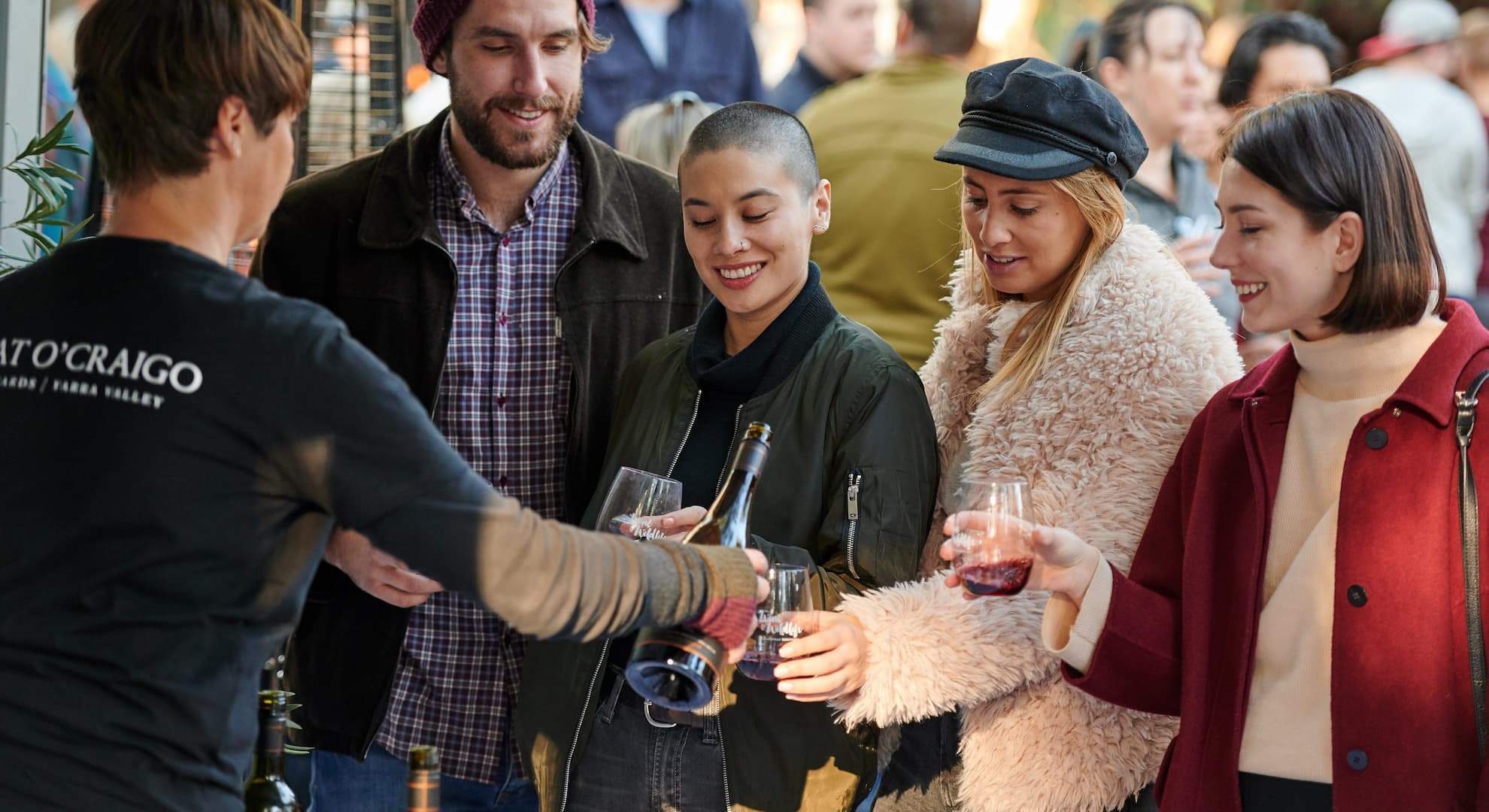 People standing around drinking wine