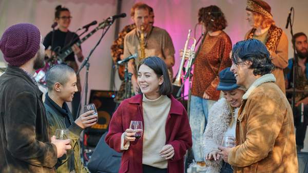 People drinking with live music in the background