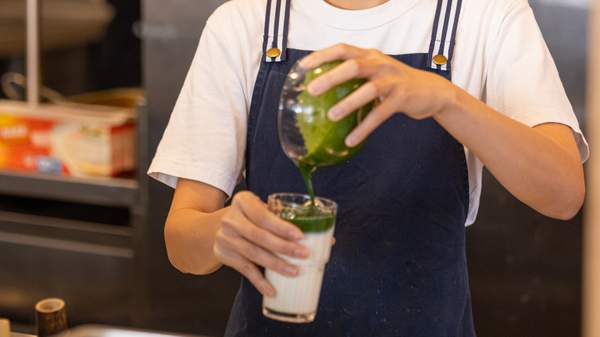 Barista pouring a matcha