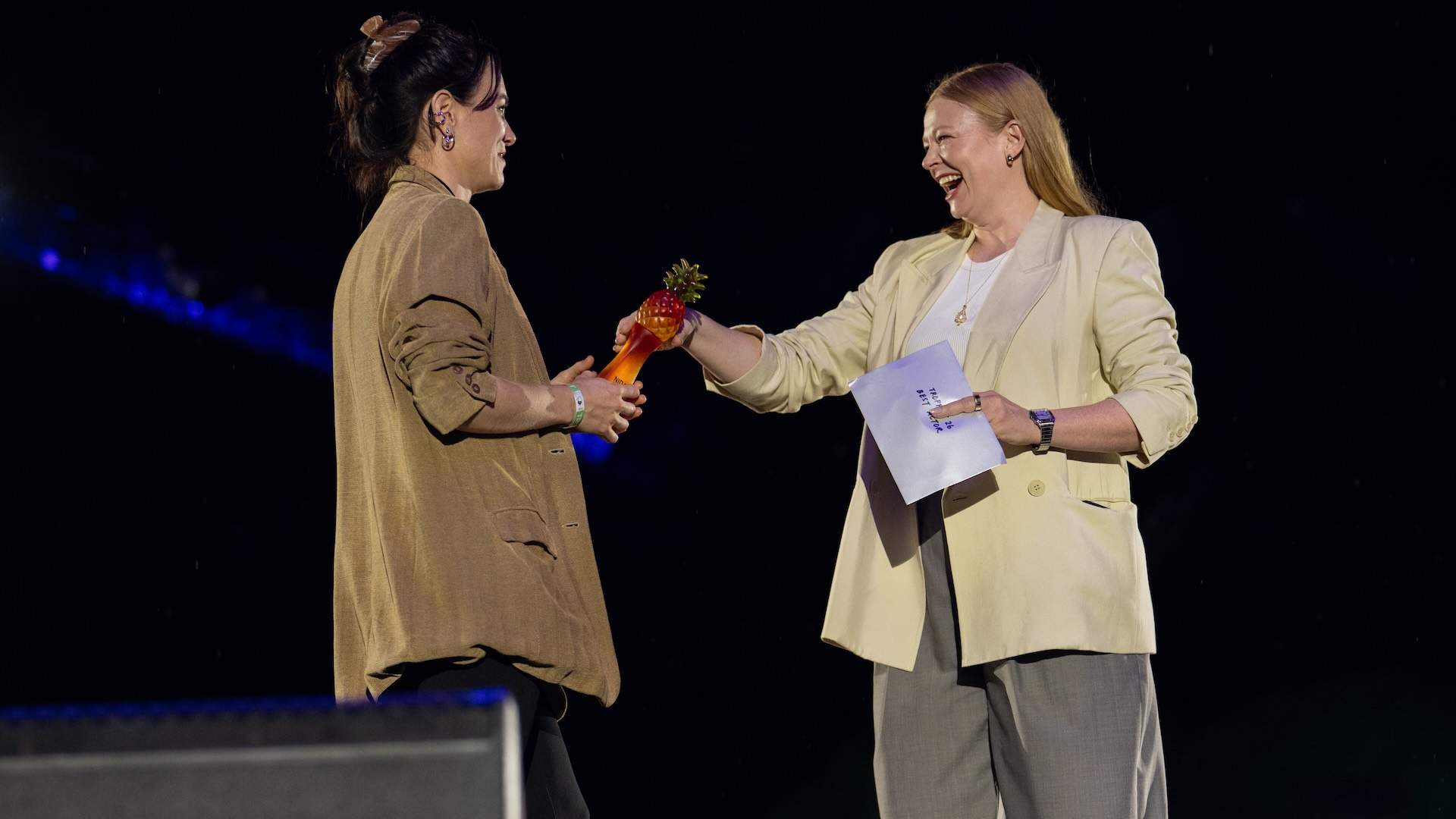 SYDNEY, AUSTRALIA - FEBRUARY 22: Sarah Snook presents the 2Emerging performer award to Laura Bunting on stage at Tropfest 2026 at Centennial Park on February 22, 2026 in Sydney, Australia. (Photo by Wendell Teodoro/Getty Images)