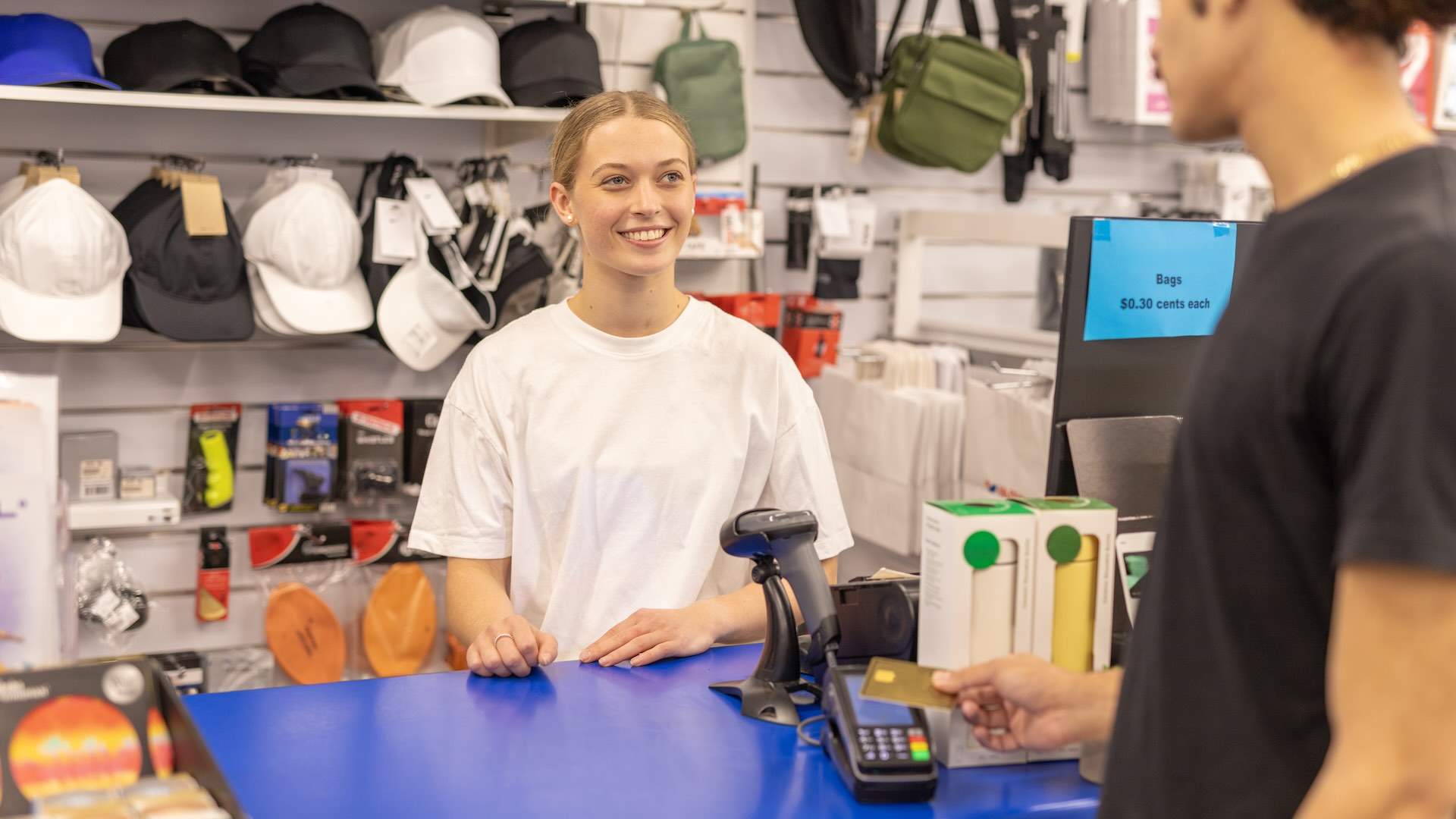 Young man making an in store credit card payment
