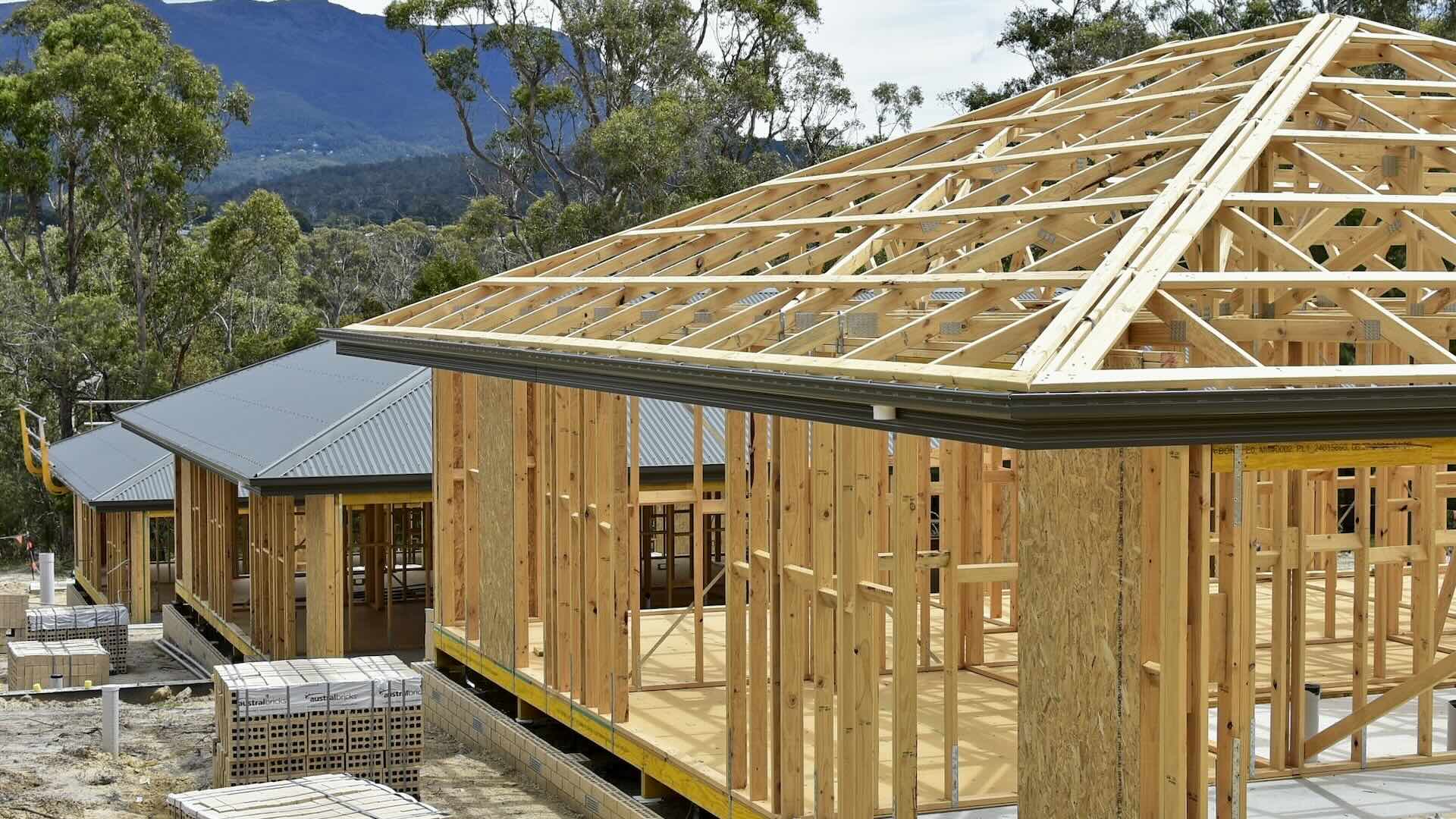 New home under construction on a housing estate; showing wall and roof frame.