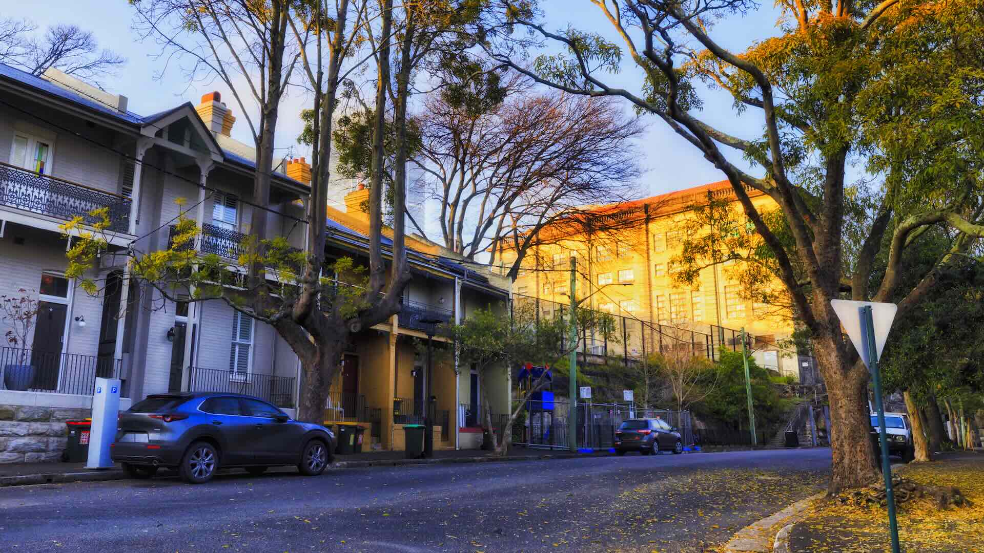 Quet local streets of The Rocks in Sydney CBD at sunrise - historic traditional terrace houses.
