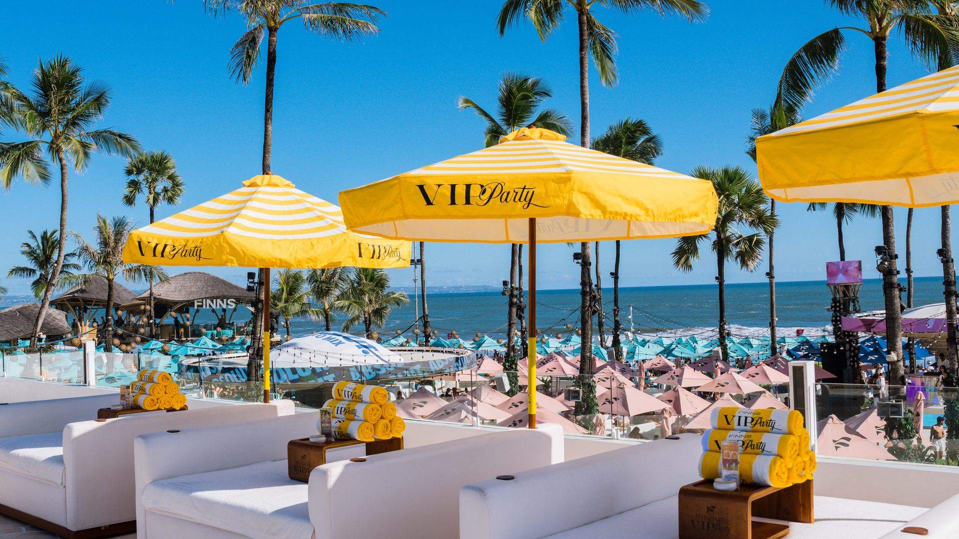 Ocean view from FINNS Beach Club's VIP section with yellow VIP Party umbrellas in Canggu, Bali