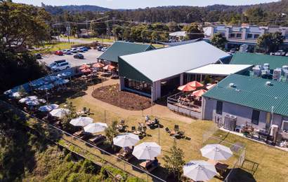 Background image for Coming Soon: This 140-Year-Old Gold Coast Pub Just Added 24 Family Cabins — Ripe for Exploring Australia's Theme Park Capital
