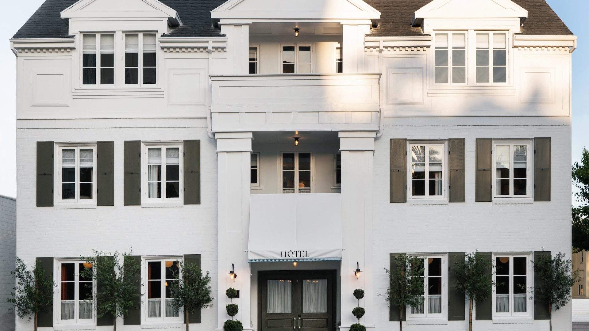 The white three-storey exterior of The Hôtel Lili on Lasky Drive, Beverly Hills