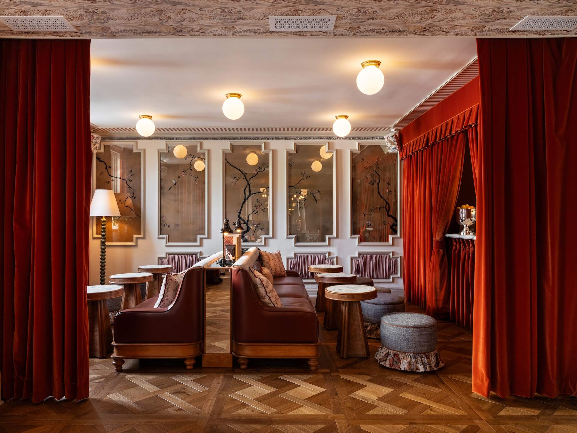 Red velvet curtains and leather banquettes in the lobby lounge at The Hôtel Lili