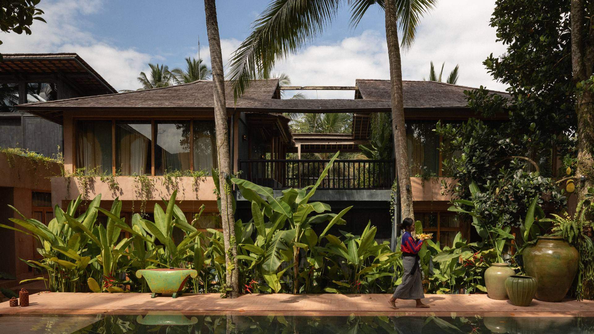 Natural pool lined with tropical plants in front of Moon Gang hotel in Ubud, Bali