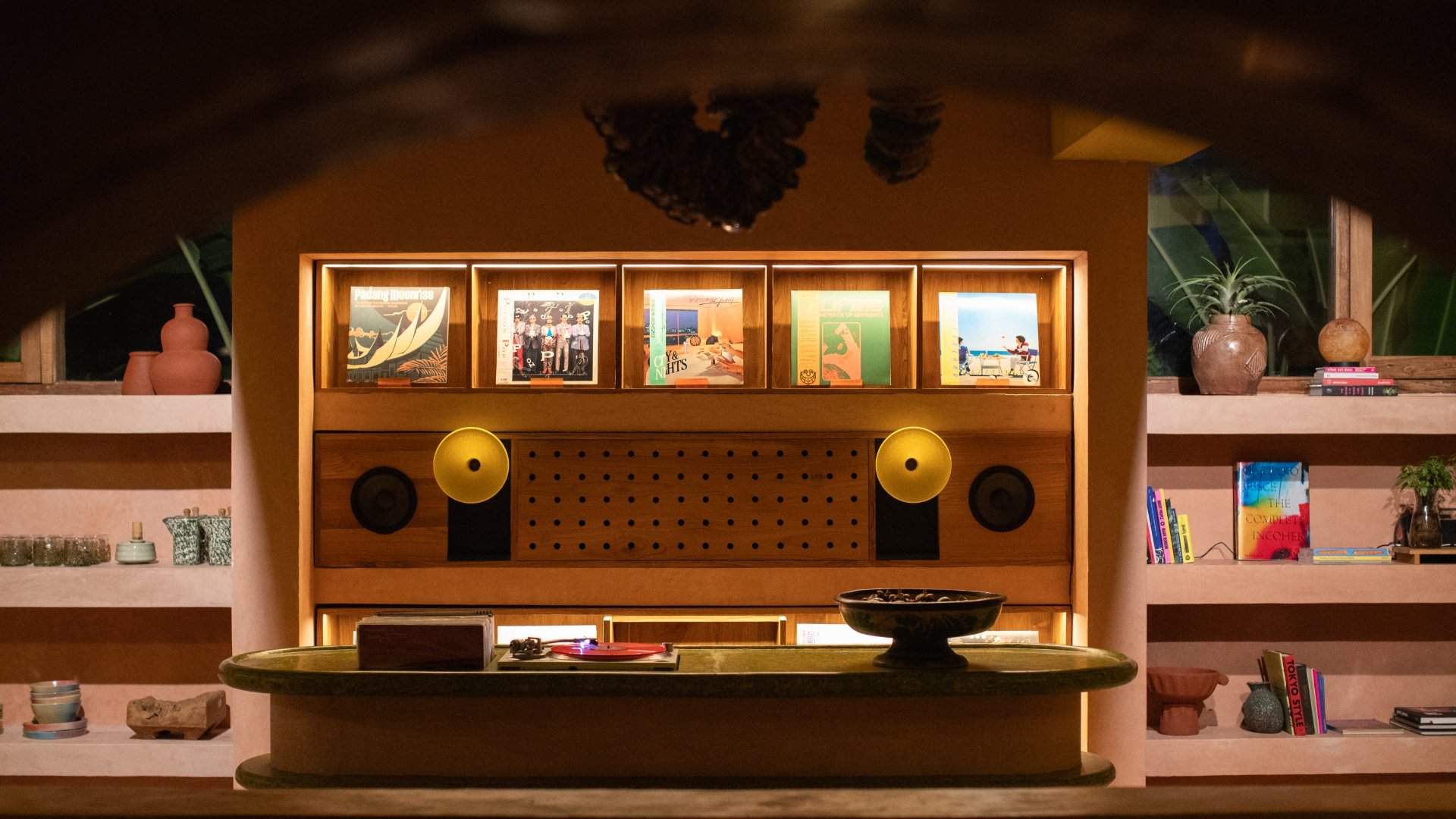 Backlit listening station with speakers and record sleeves in the Nongkrong Lounge at Moon Gang Ubud