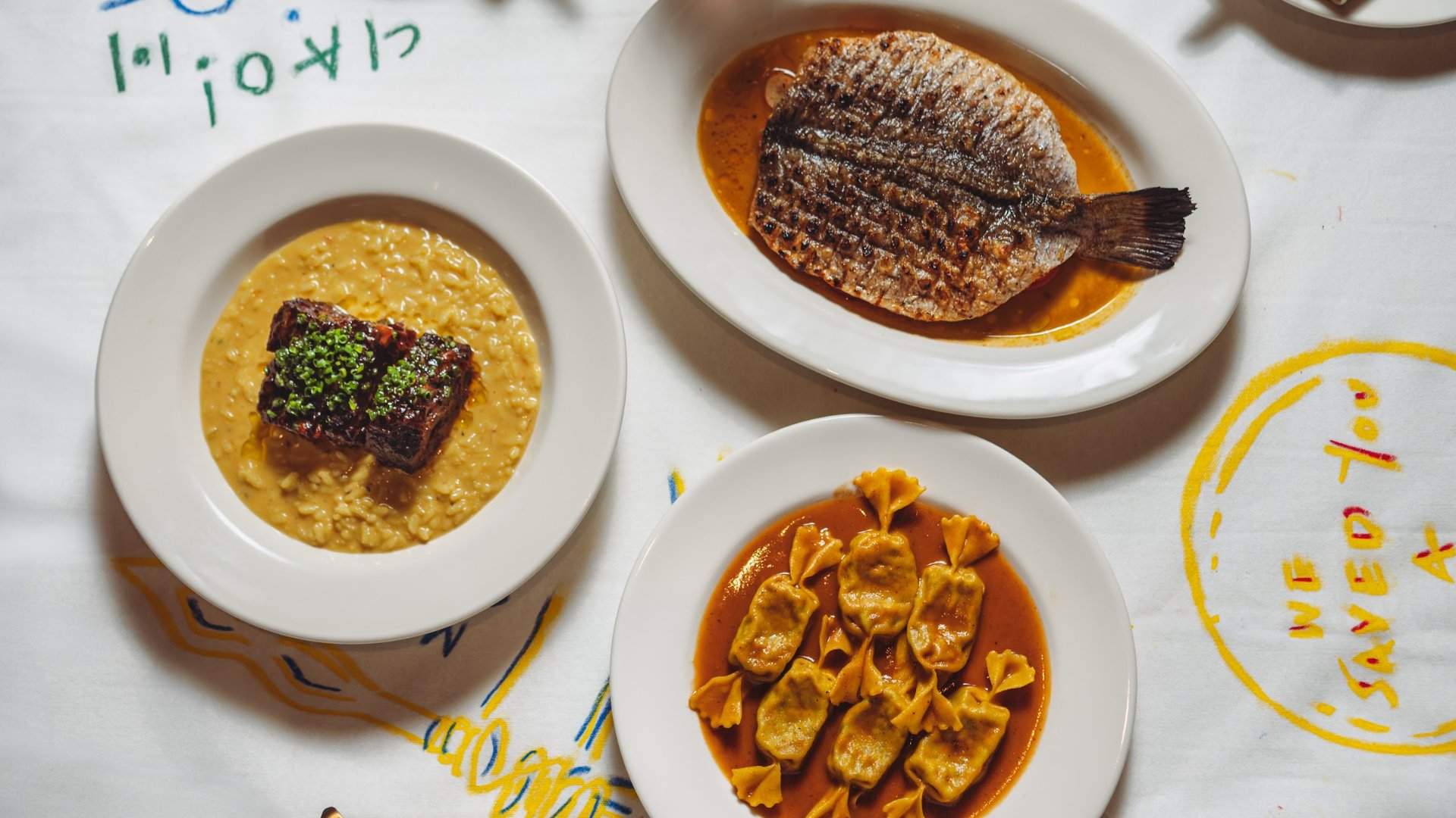 Gnocchi and shared plates on a paper-lined table at My Dear Clara