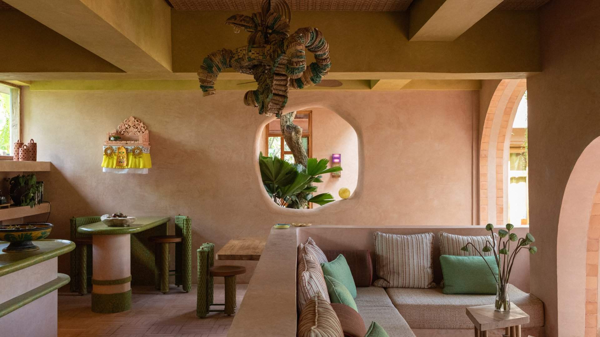 Lounge seating and a round window inside the Nongkrong Lounge at Moon Gang Ubud